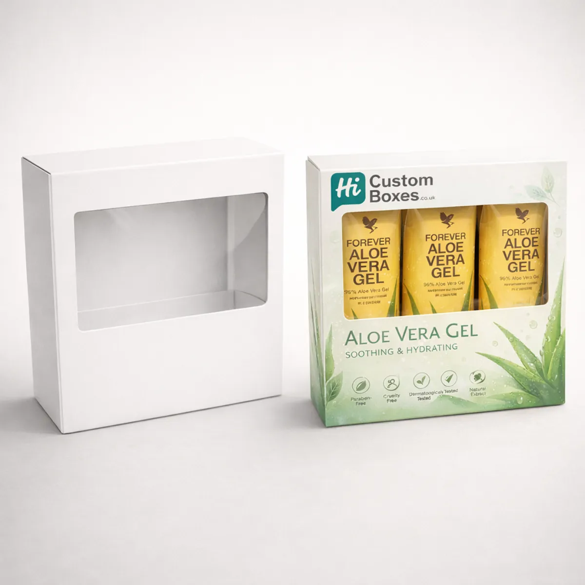 Two horizontal gift boxes with clear plastic windows: one blank white and one showing three gel tubes. class=